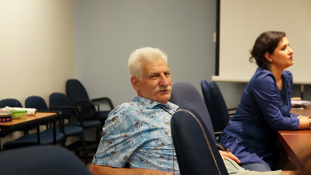 Group of adults in a seminar room engaged in discussion