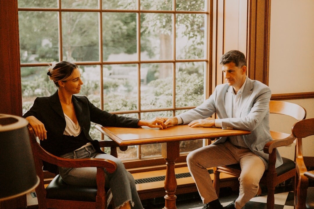 Two people having a calm conversation across a table