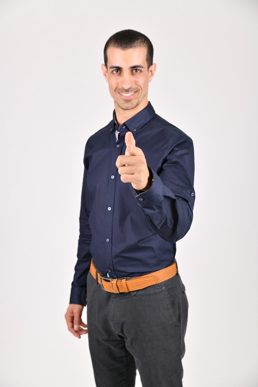 European man mid-speech gesturing confidently to an audience